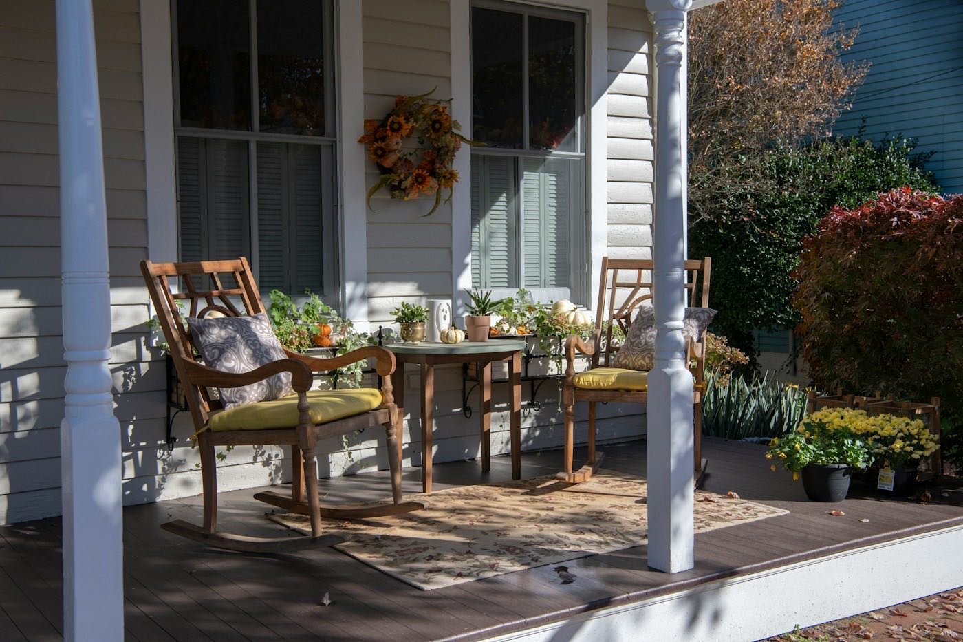 A quiet front porch with rocking chairs in daylight