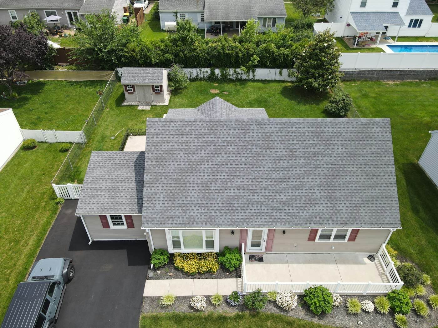 An aerial view of a house with a new gray shingle roof